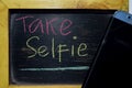 Take Selfie on phrase colorful handwritten on blackboard Royalty Free Stock Photo