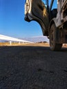 take shelter under the car and look at the view on the road