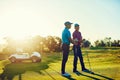 Take a swing dude. two friends playing a round of golf out on a golf course. Royalty Free Stock Photo
