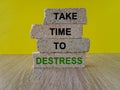 Take time to destress symbol. Concept green words Take time to destress on brick blocks. Beautiful wooden table