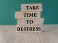 Take time to destress symbol. Concept words Take time to destress on brick blocks.
