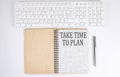 TAKE TIME TO PLAN text on the notebook with keyboard on the white background