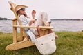 Take time to take it easy. a beautiful young woman relaxing on a chair next a lake.