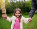 Take a walk with mommy and daddy. a young family of three enjoying a day in the park.