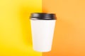 Takeaway coffee cup on orange and yellow background Royalty Free Stock Photo