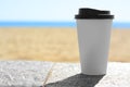 Takeaway coffee cup on stone surface outdoors. Space for text Royalty Free Stock Photo