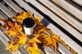 Takeaway coffee.A paper cup with espresso coffee. Autumn leaves. Wooden background. Mock up,space for text,autumn composition Royalty Free Stock Photo