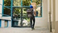 Takeaway employee trying to catch falling pizza packages