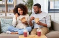 Happy couple with takeaway food and drinks at home Royalty Free Stock Photo