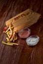 Takeaway food. french fries and vegetables in batter, carrots, sweet peppers, cured and sauces on a wooden board Royalty Free Stock Photo