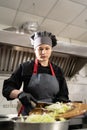 takeaway food in the restaurant. woman chef in special clothes in the kitchen prepares cabbage salad. Food delivery.