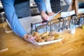 Takeaway lunch concept with waiter adding sauce on meatballs in fast food restaurant