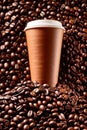 Takeaway paper cup of coffee with coffee beans