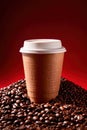 Takeaway paper cup of coffee with coffee beans