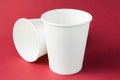 Takeaway white coffee drinking paper cup for hot tea, coffee and juice isolated  on red background, mockup Royalty Free Stock Photo