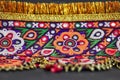 . Taken from an Antique Indian piece of Embroidery... ,closeup fragment of multi-colored floral embroidery on colorful background