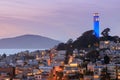 Coit Tower on Telegraph Hill with San Francisco Bay and Angel Island in the background at dusk. Royalty Free Stock Photo