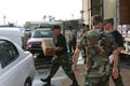 Air Force sergeant loads emergency supplies into civilian car.