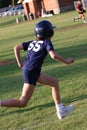 Girl Softball player races for home plate.