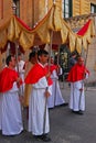 Religious festival celebration in Gozo, Malta with solemn men holding poles supporting fabric to cover probably the pastor