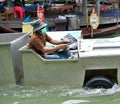 A man driving an amphibious truck at a floating market in Thailand.