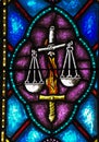 Stained Glass image of the Flaming Sword that guards Paradise and the Scales of Justice Royalty Free Stock Photo