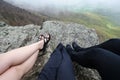 View of three woman`s legs while sitting on the summit of Stony Man Mountain in Shenandoah National Park. Concept for