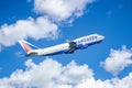 Takeoff Boeing 747 of Transaero Airlines, tail number EI-XLZ against the backdrop of picturesque clouds. International