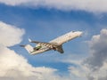 Takeoff of a business jet among beautiful clouds. A small white jet plane retracts its landing gear during takeoff Royalty Free Stock Photo