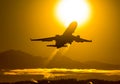 Takeoff of a passenger plane on the background of a sunset Royalty Free Stock Photo