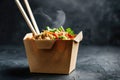 A takeout box filled with noodles and served with chopsticks Royalty Free Stock Photo
