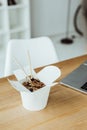 takeout box with noodles and chopsticks on workplace Royalty Free Stock Photo