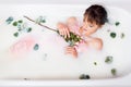 Takes a bath with milk and rose petals. Spa treatments for skin rejuvenation