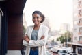 It takes big ambition to make it big. Portrait of a confident young businesswoman standing outside on the balcony of a Royalty Free Stock Photo