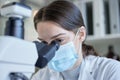 It takes a curious mind to see something. a young woman using a microscope in a lab. Royalty Free Stock Photo