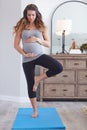 It takes a healthy body to maintain a healthy pregnancy. a pregnant young woman practicing the tree pose during a yoga Royalty Free Stock Photo