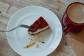 takes a piece of cheesecake with a fork for breakfast with a cup of coffee Royalty Free Stock Photo