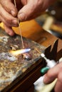 This takes a steady hand. Cropped view of a manufacturing jeweler at work with a small blow torch. Royalty Free Stock Photo