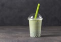 Takeway glass of iced matcha green tea latte with bubble on gray background, copy space Royalty Free Stock Photo