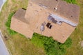 Taking an aerial view, you can see that high winds and strong storms have damaged the roof shingles