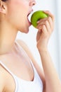 Taking a bite out of good health. Cropped view of a young woman eating an apple. Royalty Free Stock Photo