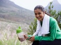 Taking a break from her hike. Portrait of an attractive young woman holding a sports drink outdoors. Royalty Free Stock Photo