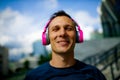 Taking a break. joyful mature gentleman in casual smiling while listening to music playing in his headphones. Royalty Free Stock Photo