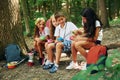 Taking a break. Kids strolling in the forest with travel equipment Royalty Free Stock Photo