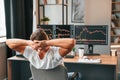 Taking a break. Young stock broker is working in the office by using computer