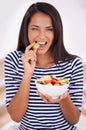 Taking a bursting bite. Portrait of a woman taking a bite of her grape. Royalty Free Stock Photo