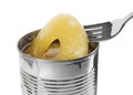 Taking canned pineapple ring from tin with fork on background, closeup Royalty Free Stock Photo