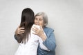 Taking care for the elderly. Young doctor hugs an elderly woman. Royalty Free Stock Photo