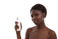 Taking care of her skin. Portrait of beautiful young african woman demonstrating cosmetic product and looking at camera Royalty Free Stock Photo