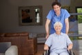 Taking care of his patients overall wellbeing. a doctor pushing his senior patient in a wheelchair. Royalty Free Stock Photo